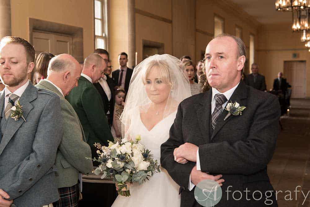 dad takes his daughter down the isle during wedding reception at hopetoun house. 