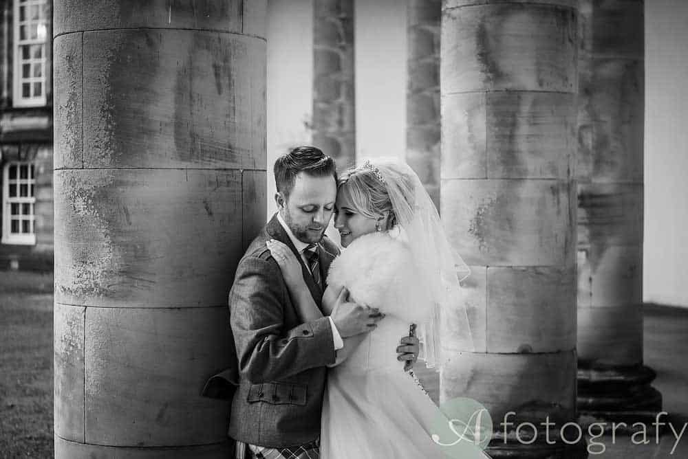 couple is posing for wedding photographer at hopetoun house Edinburgh