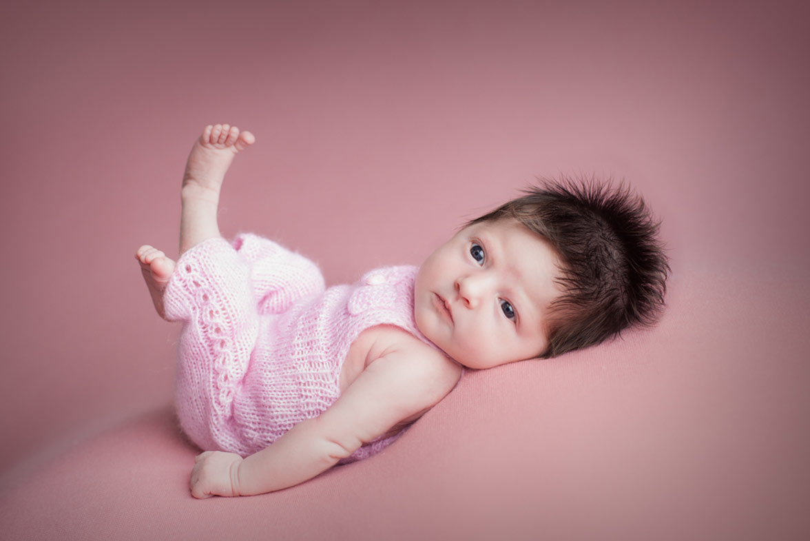 Premium Photo | Baby girl with long hair pose on black background
